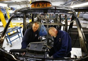 Men work on the production line at the London Taxi Company in Coventry